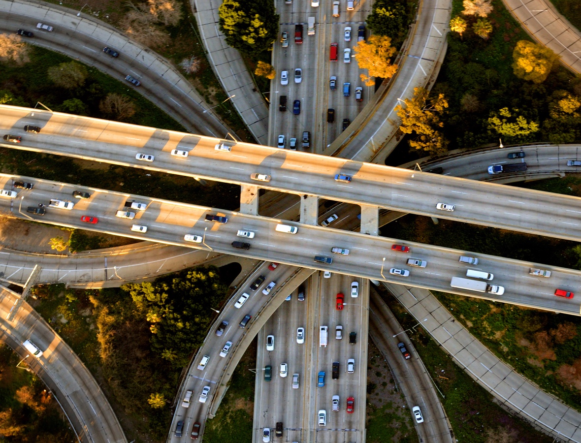 A busy highway interchange filled with traffic, illustrating the importance of secure transportation routes and logistics management by 5th Meridian Group.